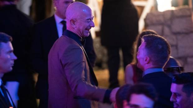 Jeff Bezos Tom Brady © Bryan WoolstonSpecial to the Courier Journal